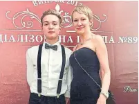  ??  ?? Roman Orlov with his mother, Tetiana Orlova, at his high school graduation last year. He was diagnosed with cancer in November.