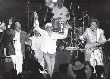  ?? LUIS M. ALVAREZ AP ?? From left, brothers and Gap Band members Ronnie, Charlie and Robert Wilson acknowledg­e the crowd after performing at the 2005 BMI Urban Music Awards in Miami Beach.