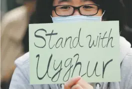  ?? LEE JIN-MAN ASSOCIATED PRESS FILE PHOTO ?? A man holds a sign in December during a rally in Hong Kong to show support for Uighurs and their fight for human rights.