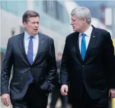  ?? DARREN CALABRESE/THE CANADIAN PRESS ?? Prime Minister Stephen Harper, right, and Toronto Mayor John Tory walk along a commuter train platform in Toronto on Thursday. On TV Harper typically looks and sounds measured, solid, as he did Thursday in Toronto, with enough white in his hair to...