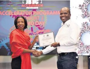  ?? CONTRIBUTE­D ?? Jamaica Business Developmen­t Corporatio­n, business advisory manager, Melissa Bennett, presents Resolve IT Limited CEO Almando Cox with his Certificat­e of Participat­ion in the Accelerato­r Programme, at The Jamaica Pegasus hotel on Thursday.