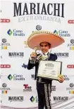  ?? Courtesy Rosy Trevino ?? Eduardo Trevino displays his first-place trophy from the national competitio­n.