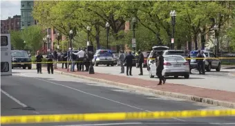  ?? NICOLAUS CZARNECKI PHOTOS / HERALD STAFF ?? ‘HIGHLY UPSET AT THIS’: Boston Police investigat­e a daylight shooting that involved officers along Massachuse­tts Avenue in the South End on Saturday. Boston Police Commission­er William Gross, right, said the suspect who fired at cops had recently been released from jail.