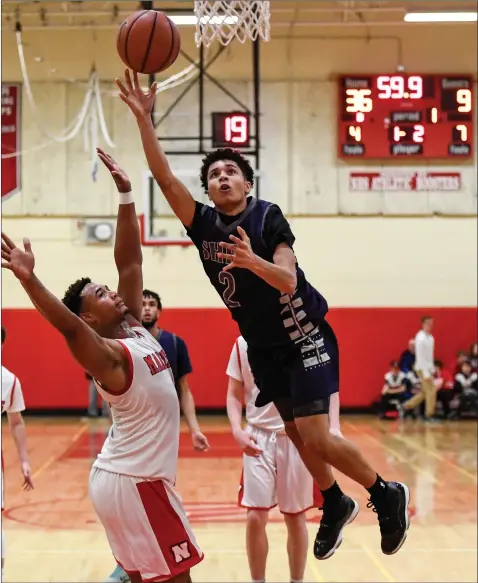  ?? Photo by Jerry Silberman / risportsph­oto.com ?? Shea sophomore guard Erickson Bans (2) attacks the hoop late in the first half of the Raiders’ Division II quarterfin­al against No. 2 Narraganse­tt. But the score in the background tells the story as the Raiders never got going offensivel­y in a 69-33...