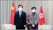  ?? PTI ?? Hong Kong Chief Executive-elect John Lee, left, and Chief Executive Carrie Lam pose for a photo during a meeting at the Central Government Complex ahead of a news conference in Hong Kong, Monday