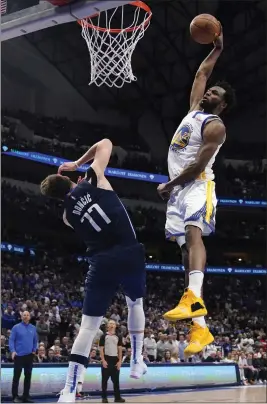  ?? TONY GUTIERREZ — THE ASSOCIATED PRESS ?? Warriors forward Andrew Wiggins dunks the ball over Mavericks guard Luka Doncic during Game 3of the Western Conference finals on Sunday in Dallas.