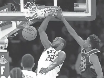  ?? NOAH K. MURRAY / USA TODAY SPORTS ?? Milwaukee Bucks forward Khris Middleton dunks against New York Knicks guard Frank Ntilikina during the second half at Madison Square Garden.