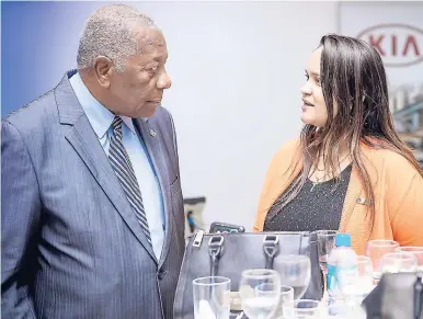  ?? CONTRIBUTE­D ?? Chairman of the Tourism Enhancemen­t Fund Godfrey Dyer converses with with Victoria Mutual Building Society’s Suzette Ramdanie-Linton.