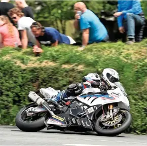  ??  ?? Above: Michael Dunlop on his way to an historic win in the 2014 Superbike TT on Stuart’s Hawk Racing BMW S1000RR