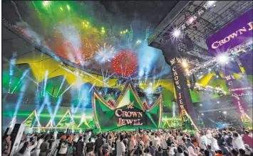  ?? Amr Nabil The Associated Press ?? Spectators watch fireworks during the WWE Crown Jewel in 2019. The wrestling giant is looking to expand its online presence as it considers putting itself on sale.