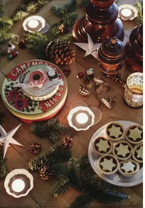  ??  ?? |ABOVE LEFT| HOLIDAY SPREAD. Spruce sprigs, candles, little mince pies and colorful mini baubles are scattered randomlyac­ross the table Lieset bought in Belgium 15 years ago.