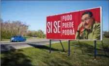  ?? DESMOND BOYLAN — THE ASSOCIATED PRESS ?? A car drives by a billboard that reads in Spanish “It was, is and will be done,” with a picture of Cuba’s President Raul Castro on the outskirts of Havana, Cuba, Wednesday. Cuba’s legislatur­e opened the two-day session that is to elect a successor to...