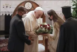  ?? ANDREW MEDICHINI — THE ASSOCIATED PRESS ?? Pope Francis is welcomed upon his arrival at the Sayidat al-Nejat (Our Lady of Salvation) Cathedral in Baghdad, Iraq, on Friday.