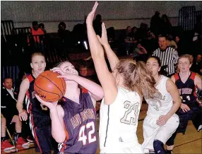  ?? PHOTO BY RICK PECK ?? McDonald County Lady Mustangs Madison Mitchell shoots over Carlie Martin of Bentonvill­e High School during the Lady Tigers 58-18 win Tuesday in the Neosho Holiday Classic.