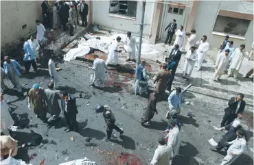  ?? (Naseer Ahmed/Reuters) ?? POLICE AND hospital staff tend to the wounded of a bomb blast outside a hospital in Quetta yesterday.