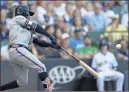  ?? / AP- Aaron Gash ?? Atlanta Braves’ Ozzie Albies hits an RBI double during the first inning of a baseball game against the Milwaukee Brewers on July 6 in Milwaukee.
