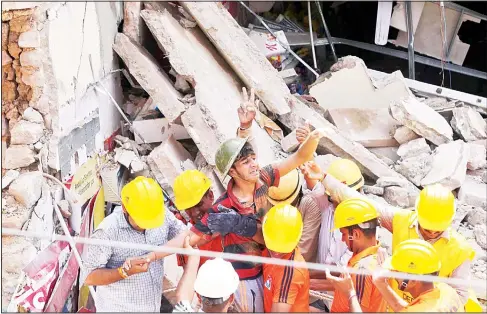  ??  ?? Rescue workers carry a man pulled out from the debris of a building that collapsed in Jodhpur, India on May 22. A building collapsed in the northern Indian town Tuesday
morning and many are feared still trapped in the debris. (AP)