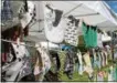  ??  ?? Bibs and other items are displayed at the 2017 Markets at Round Lake.