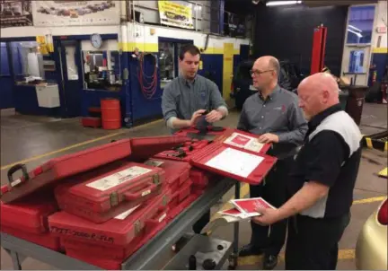  ?? CHAD FELTON — THE NEWS-HERALD ?? Chris Hayden, left, Auburn Career Center Superinten­dent Brian Bontempo, center, and Automotive Technology instructor Tom Welk, discuss service equipment at the center on Nov. 21. Earlier this month, Hayden, an engineer at STERIS Corp. in Mentor, donated $30,000 worth of tools to the school’s program.