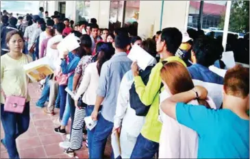  ?? LEONIE KIJEWSKI ?? People stand in a queue to apply for Cambodian passports at the passport office in Phnom Penh last year.