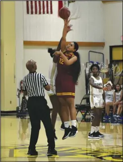  ?? MEGAN WIDICK Special to the Valley Press ?? HIGHER JUMP Highland’s Azha Dickson (12) gets her hand on the ball to win the jump ball against Knight’s Blessing McBride during Tuesday’s Golden League game. Dickson scored 18 points to lead the Bulldogs to a 45-33 victory.