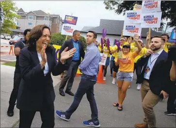 ?? JUSTIN SULLIVAN Getty Images ?? KAMALA HARRIS greets supporters in Clear Lake, Iowa. “She’s tough, she’s not a starry-eyed liberal — look at her background as a prosecutor,” said one supporter, a retired farmer. “It appeals to someone like me.”