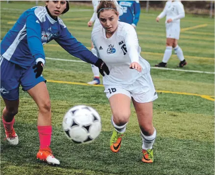  ?? BERND FRANKE THE ST. CATHARINES STANDARD ?? Niagara's Michelle Maecker, right, races to keep the ball in play in women's college soccer playoff action versus George Brown Saturday at Youngs Sportplex in Welland.