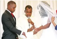  ?? ?? Mr Macdonald Simenti and Sarah Dumba being joined in Holy matrimony by Roman Catholic priest Father Majinga in Kanyemba recently