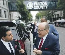  ?? John Bazemore Associated Press ?? RUDOLPH W. GIULIANI, right, shown at the Fulton County Courthouse in Atlanta in August, was described as funny by the foreperson of the grand jury.