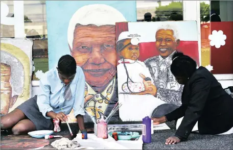  ?? Picture: NHLANHLA PHILLIPS ?? HEALING LEGACY: Hazel Mucabela and Angel Sirenje painting portraits of Madiba at the opening of the Nelson Mandela Children’s Hospital in the Eastern Cape.
