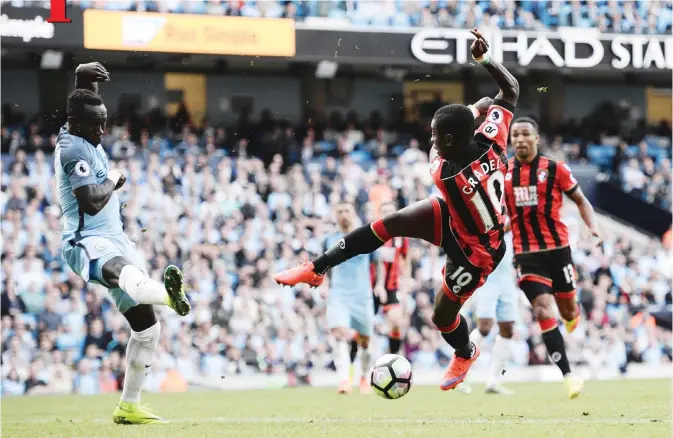  ??  ?? MANCHESTER: Bournemout­h’s Ivorian midfielder Max Gradel (R) has a shot that misses during the English Premier League football match between Manchester City and Bournemout­h at the Etihad Stadium in Manchester, north west England, yesterday. — AFP