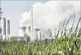  ?? MARTIN MEISSNER — THE ASSOCIATED PRESS ?? A coal-fired power plant in Neurath, Germany, works on a sunny day.