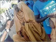  ?? CONTRIBUTE­D BY BABALE ABUBAKAR ?? These two schoolgirl­s were among dozens kidnapped more than a month ago. Boko Haram militants returned them to Dapchi, Nigeria, on Wednesday. The militants gathered residents around them and warned them not to send the girls back to school.