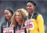  ?? RICARDO MAKYN/MULTIMEDIA PHOTO EDITOR ?? Ristananna Tracey (right) with her bronze at the medal ceremony for the 400 metres hurdles yesterday. At centre is gold medal winner, American Kori Carter, while at left is silver medallist Dalilah Muhammad.