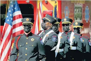  ?? MIKE STOCKER / SOUTH FLORIDA SUN SENTINEL ?? Members of the Boynton Beach Fire Department Honor Guard participat­e in the ceremony for the city of Boynton Beach on Saturday to remember the lives lost and heroes of 9/11 on the 20th anniversar­y.