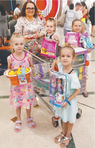  ?? Picture: BRENDAN RADKE ?? BANG FOR BUCK: Jodie Reeves was out shopping for toys at Cairns Central for her granddaugh­ters Layla, Talia, Yulara and Lola Munt-Scott.