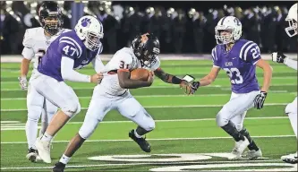  ?? / Keith Deal ?? Lafayette running back Jamario Clements tries to pull away from a Gilmer defender. Clements had a 20-yard touchdown run in the Ramblers’ season-ending victory in Ellijay this past Thursday.