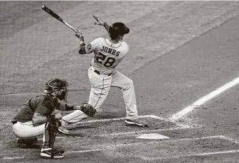  ?? Justin Edmonds / Getty Images ?? Astros DH Taylor Jones, who was called up to replace Yordan Alvarez on the roster, follows through on a fifth-inning single for his first MLB hit. Jones drove in Kyle Tucker with the single.