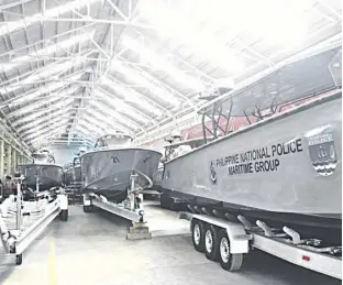  ??  ?? SOME of the 21 high-speed tactical watercraft built by Safehull Marine await delivery at the firm’s warehouse in the Subic Bay Freeport Zone.