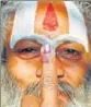  ??  ?? A sadhu shows his inked finger after casting his vote in Ayodhya on Monday.