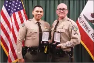  ?? PHOTO COURTESY OF TULARE COUNTY SHERIFF’S OFFICE ?? Sheriff Mike Boudreaux awarded Dep. Juan Serrano, left, the Purple Heart and Dep. Daniel Villalobos, right, the Medal of Valor during a special awards ceremony Tuesday, Sept. 11 at Headquarte­rs.