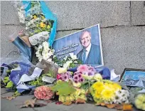  ?? ?? Tributes Floral tributes to Sir David Amess MP, who was stabbed to death during a constituen­cy surgery last month, outside Parliament in London