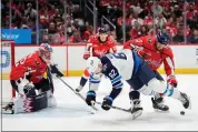  ?? MARK SCHIEFELBE­IN — THE ASSOCIATED PRESS ?? Winnipeg Jets right wing Nino Niederreit­er (62) battles for the puck with Washington Capitals defenseman Nick Jensen (3) in the second period of an NHL hockey game, Sunday, March 24, 2024, in Washington.