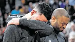  ?? David Zalubowski / Associated Press ?? Guard Austin Rivers, left, and forward P.J. Tucker fight tears during a tribute to Kobe Bryant before the Rockets’ game at Denver on Sunday.