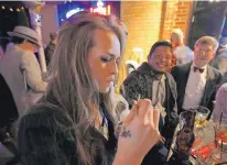  ?? BRENNAN LINSLEY/ASSOCIATED PRESS ?? Partygoers smoke marijuana during a Prohibitio­n-era themed New Year’s Eve invitation-only party celebratin­g the start of retail pot sales, at a bar in Denver. Colorado is on the brink of becoming the first state with licensed pot clubs.