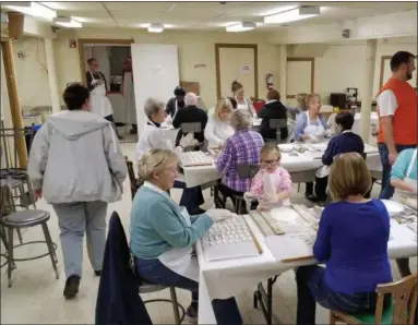  ??  ?? A volunteer makes chocolate-covered candy at St. Mark’s Lutheran Church in Conshohock­en.