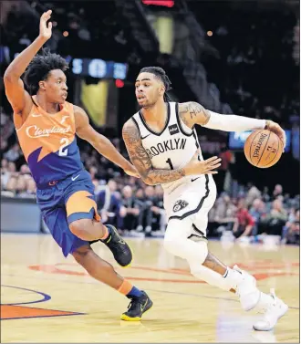  ?? [TONY DEJAK/THE ASSOCIATED PRESS] ?? Brooklyn’s D’angelo Russell drives against Cleveland’s Collin Sexton during Wednesday’s game.