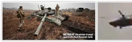  ?? ?? Ukrainian troops guard ditched Russian tank