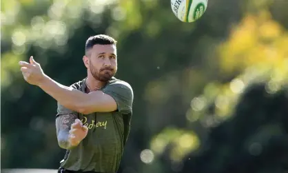  ?? Photograph: Dave Hunt/AAP ?? Quade Cooper passes the ball during a Wallabies training session at Sanctuary Cove on the Gold Coast.