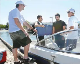  ?? GARY NYLANDER/ Special to The Herald ?? Brett Philip, left, and Colby Martens of SunWave Boat Rental rent a boat out to Parm Randhawa, second left and Ali Hussain as they get ready to head out onto the lake for a spin from the Water Street Boat Launch on Monday.